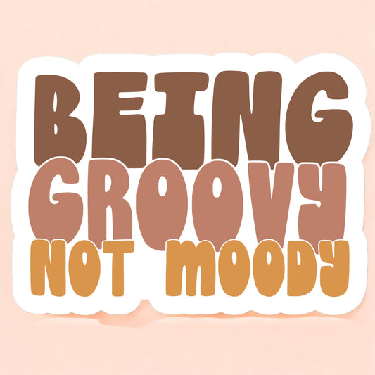 a sticker that reads being groovy not moody in brown, taupe, and orange yellow on a white background in a retro font