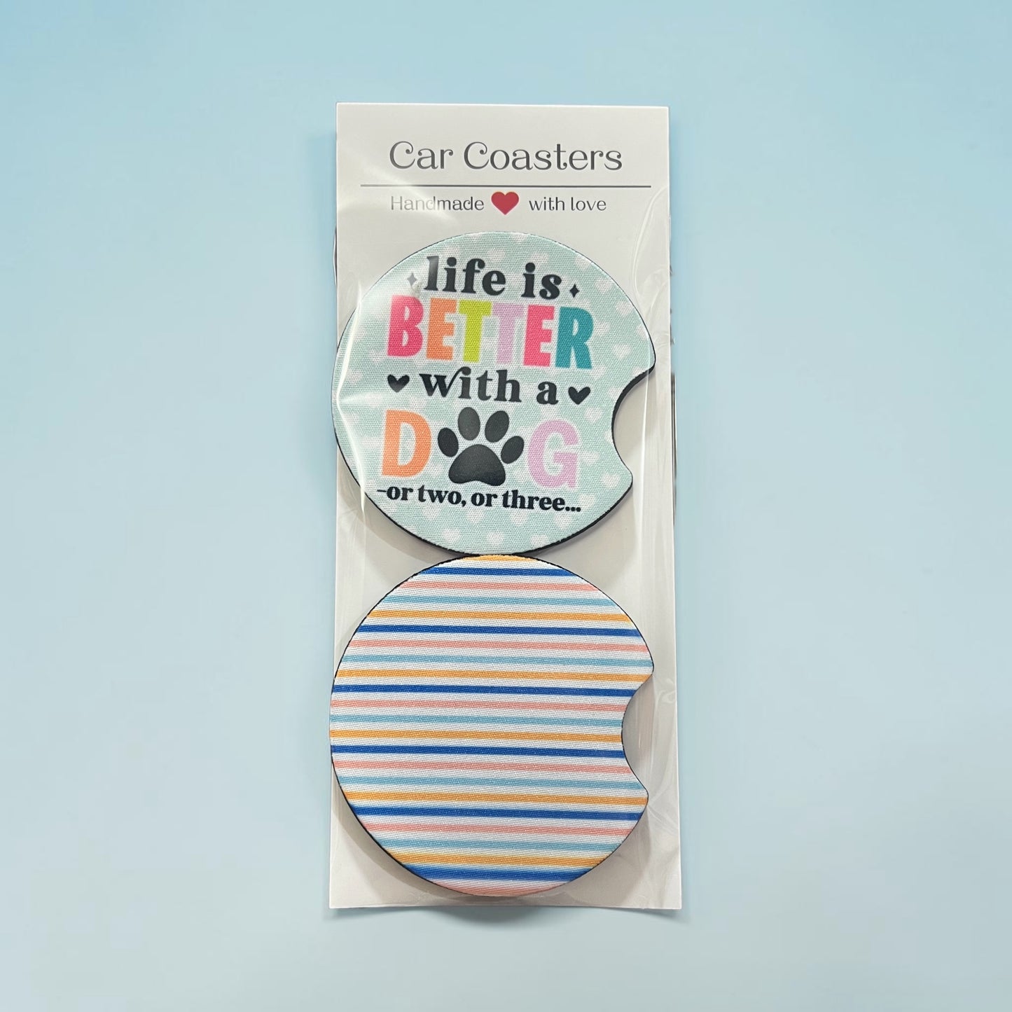 Car coasters with motivational text and a paw print design on a light blue background