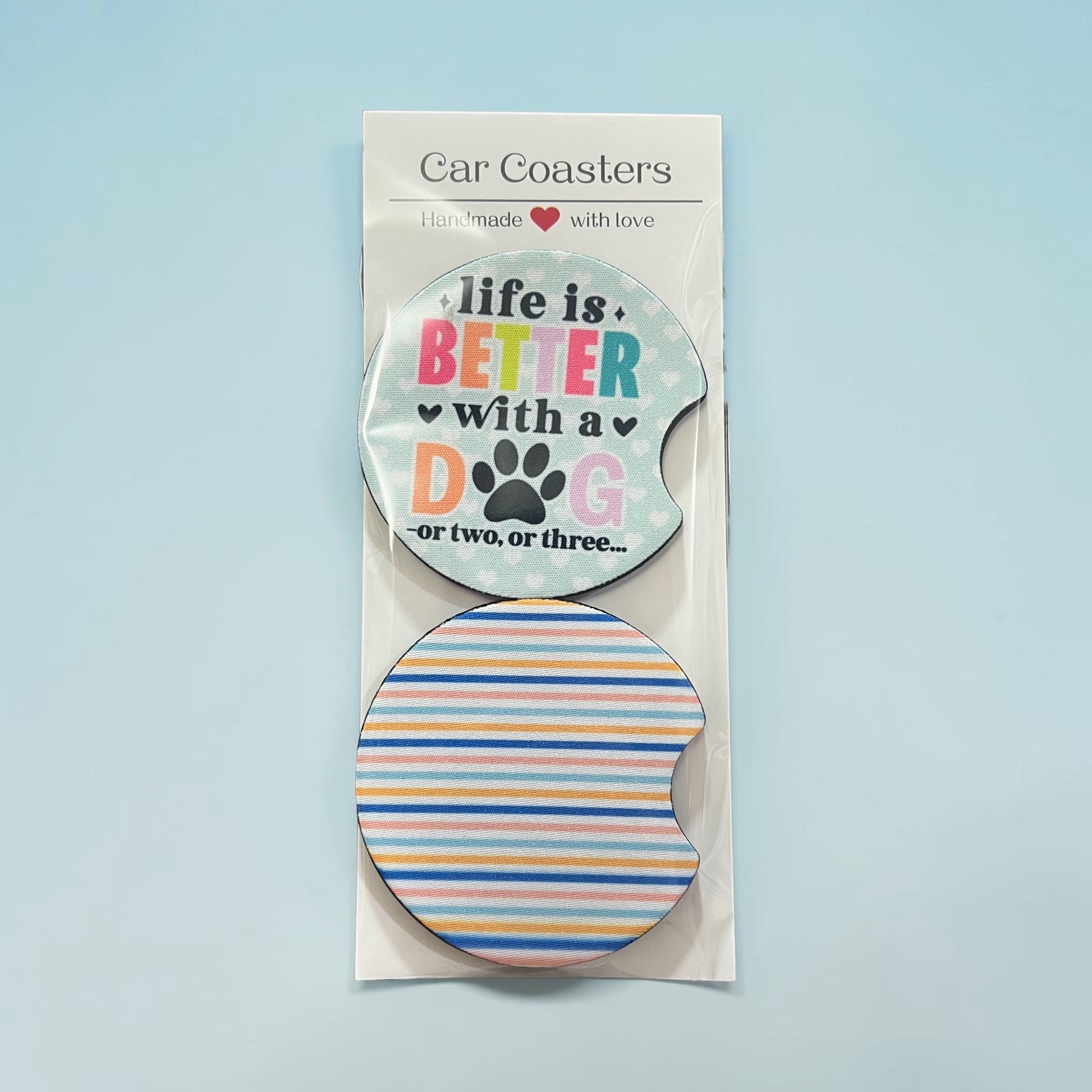 Car coasters with motivational text and a paw print design on a light blue background