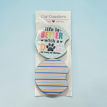 Car coasters with motivational text and a paw print design on a light blue background