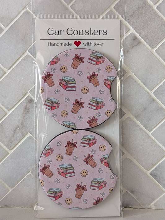 Car coasters with a pink pattern in packaging on a tiled surface