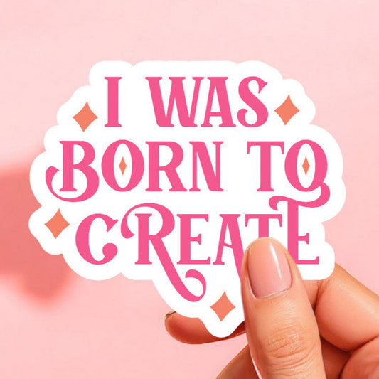 a white sticker that reads i was born to create in hot pink retro font