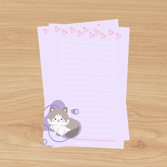 This 4"x6" notepad is made of high-quality paper, printed in house by Midnight Dahlia Studio.

It is purple and has a cute grey cat at the bottom.  Each notepad contains 50 pages.