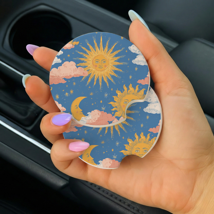 Hand holding a car coaster with sun and cloud design