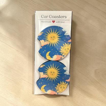 Pack of car coasters with sun and moon design on a wooden surface