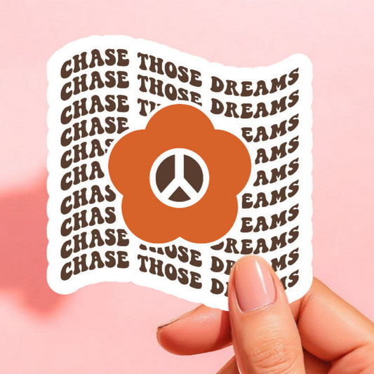a sticker that reads chase those dreams repeated with a daisy with a peace sign center in orange and brown