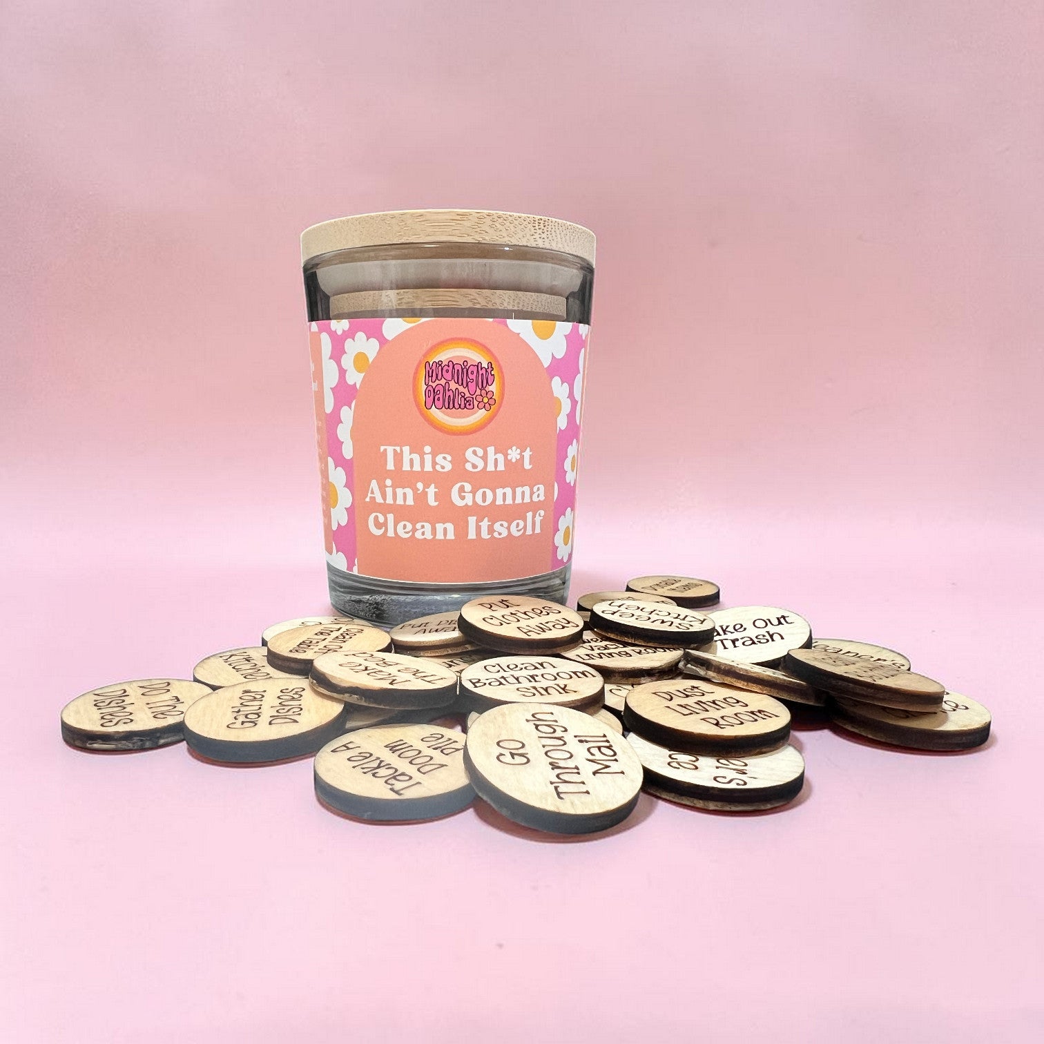 Jar of cleaning-themed tokens with humorous text on a pink background