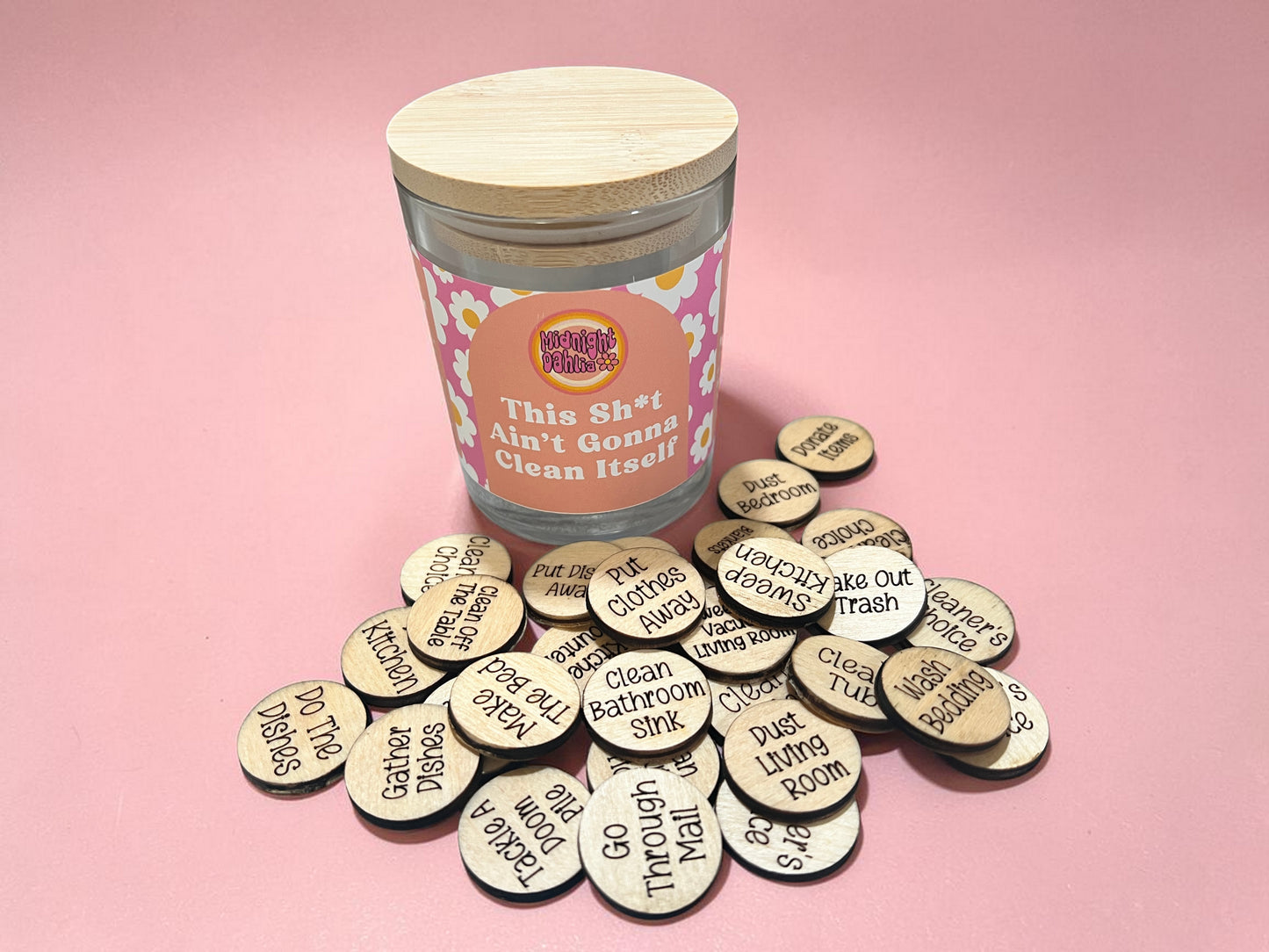Jar of cleaning-themed tokens with humorous text on a pink background