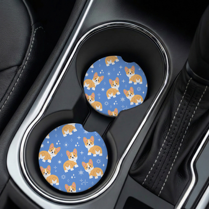 Two blue car coasters with corgi pattern in a car cup holder.