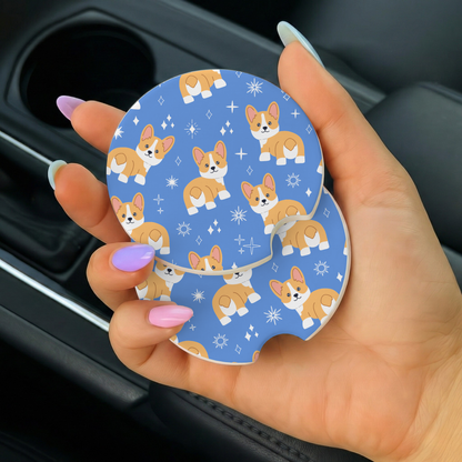Hand holding a car coaster with corgi pattern inside a vehicle.