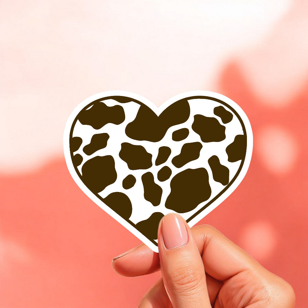 a heart shaped white sticker with brown cow print