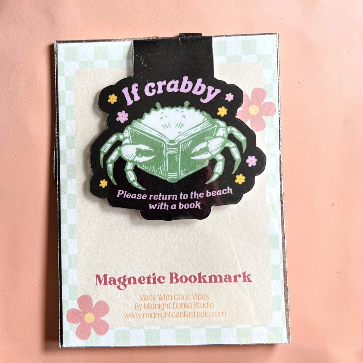 Magnetic bookmark with crab design and text on a checkered background