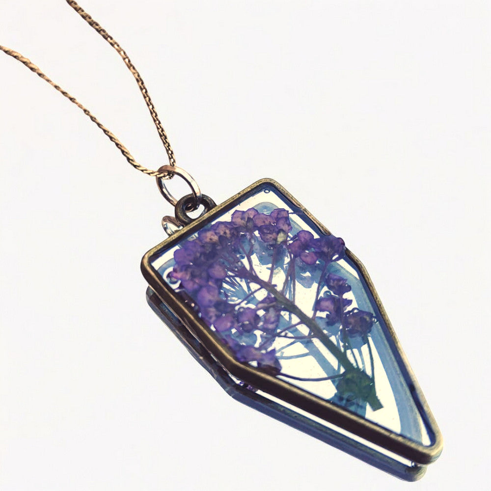 A custom resin necklace with pressed purple queen annes lace flower.  Beautiful add-on for a bridal bouquet preservation.