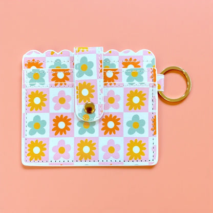 Floral patterned keychain card holder on a pink background