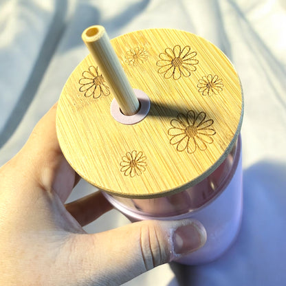 a bamboo tumbler top engraved with daisies