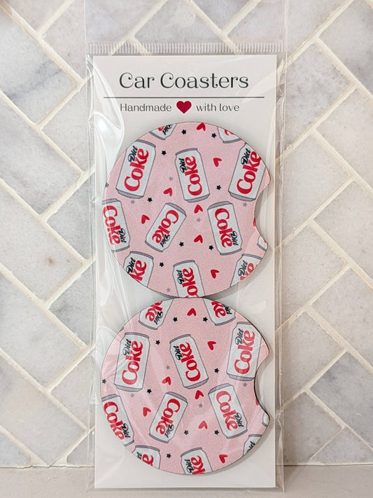 Packaged car coasters with Coca-Cola design on a tiled surface