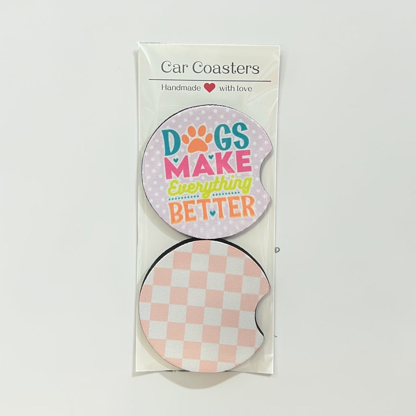 Packaged car coasters with a checkered design and 'Dogs Make Everything Better' text on a white background.