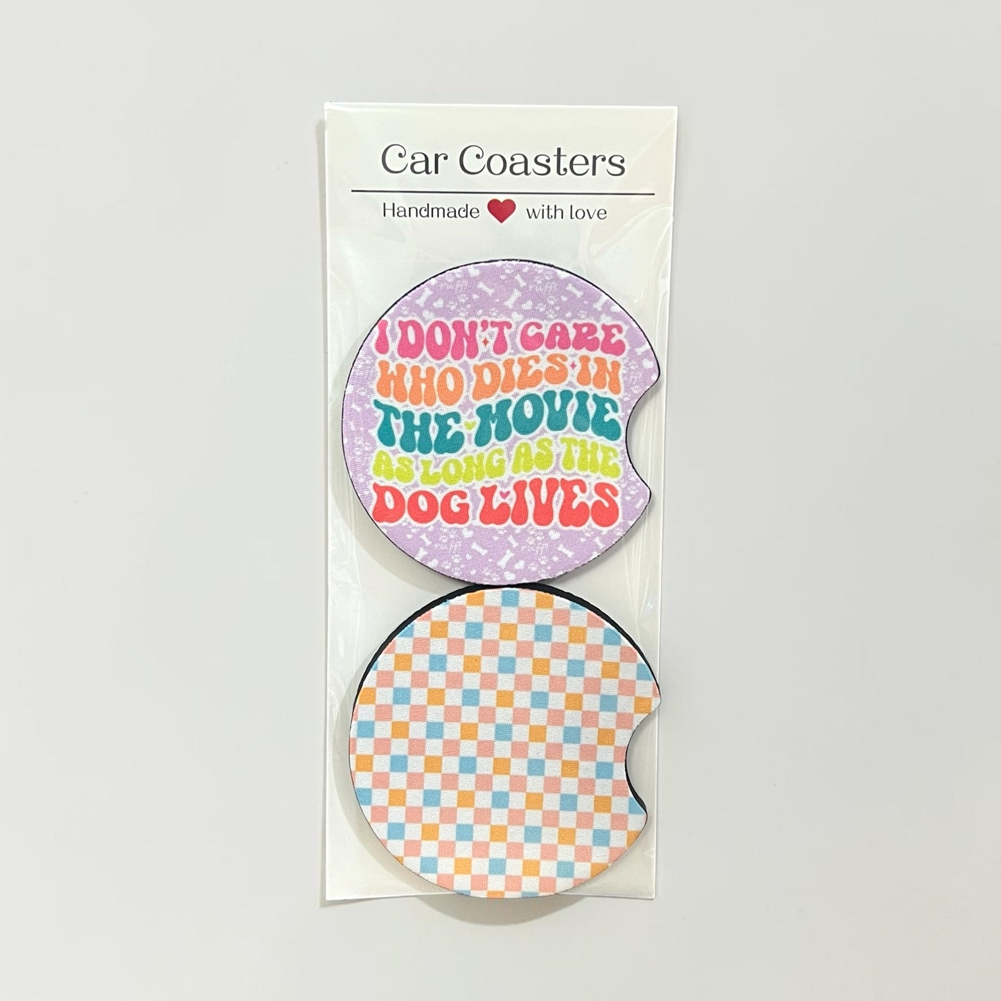 Two car coasters with humorous text design on a white background
