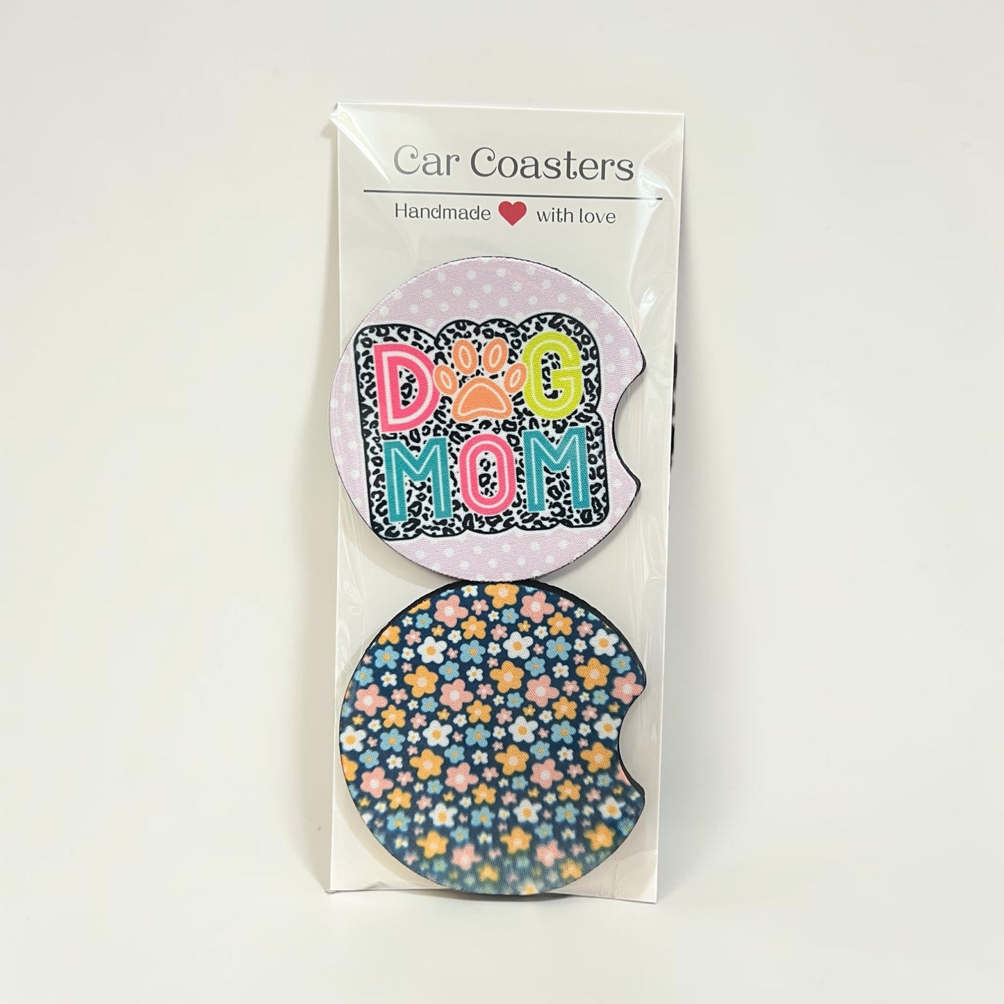 Packaged car coasters with 'Dog Mom' design on a white background