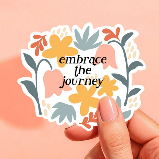 a white background sticker that reads embrace the journey in black in front of artistic floral pattern