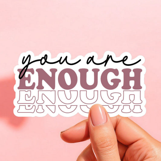 a white sticker that reads you are enough with a repeated shadow of the word enough
