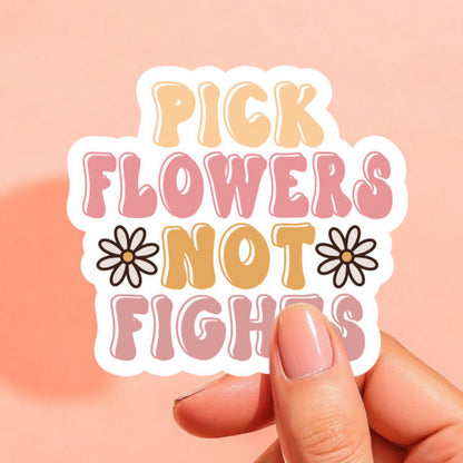 a colorful sticker that reads pick flowers not fights with two white daisies on either side of the words