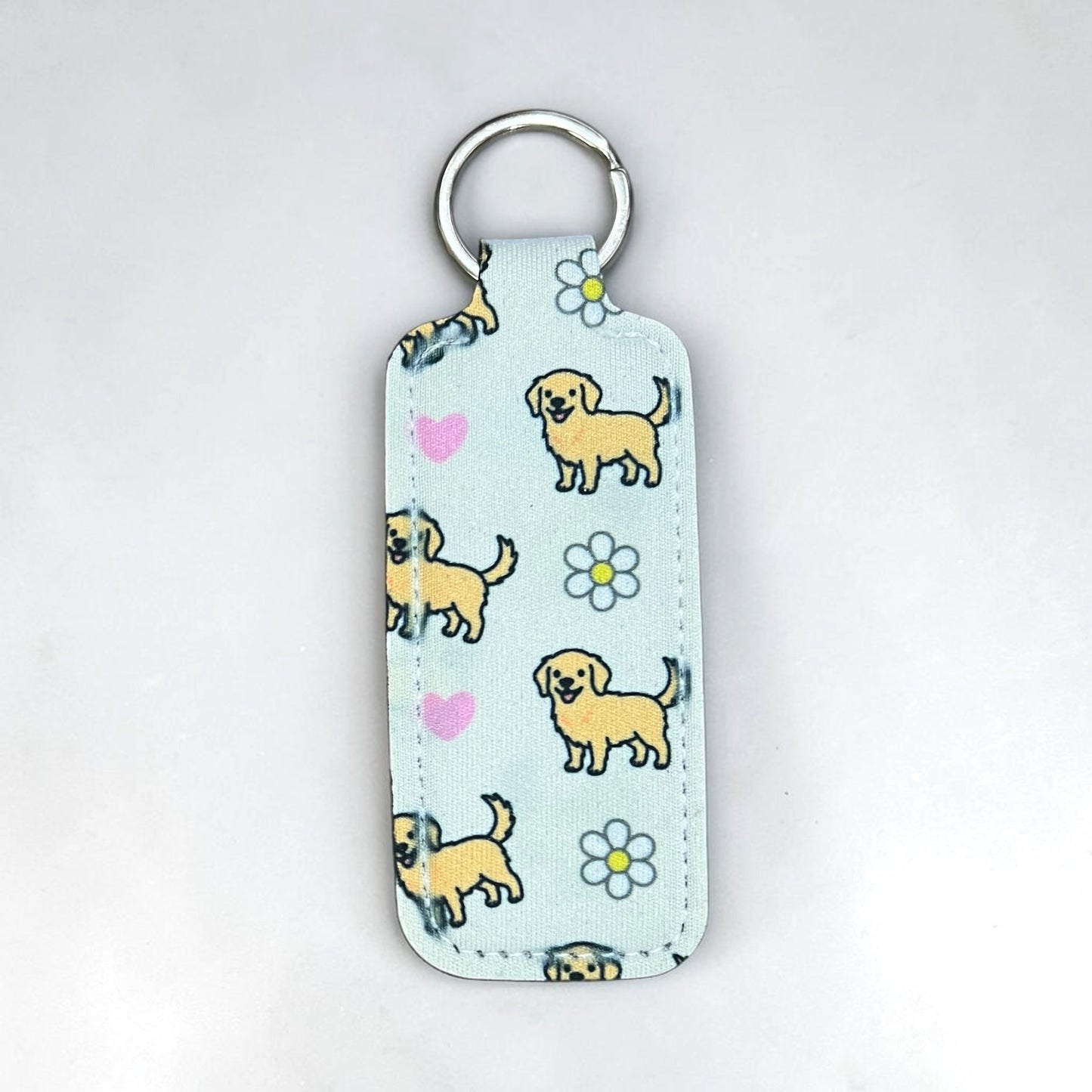 Keychain with dog pattern on a light blue background