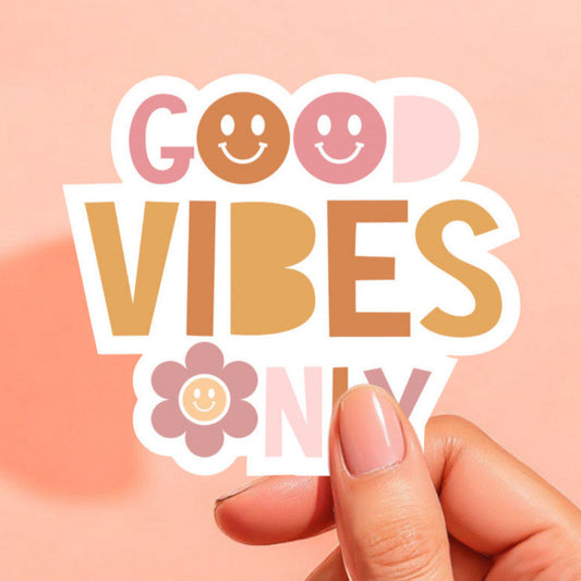 a white background sticker that reads good vibes only with smiley faces for the o's in light pink, peach, orange, and mauve pink