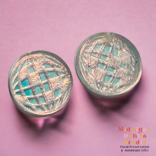 small iridescent disco ball stud earrings on a pink background.  perfect gift for women and teens, especially swifties fans of taylor swift.