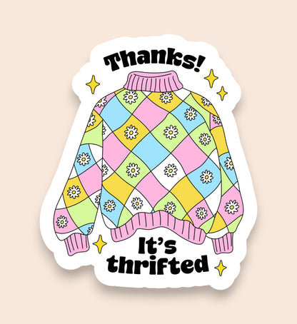 Colorful sweater design sticker with 'Thanks! It's thrifted' text on a beige background