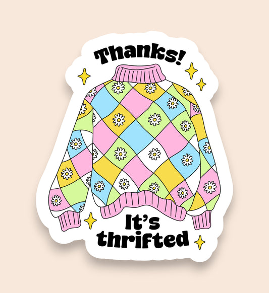 Colorful sweater design sticker with 'Thanks! It's thrifted' text on a beige background