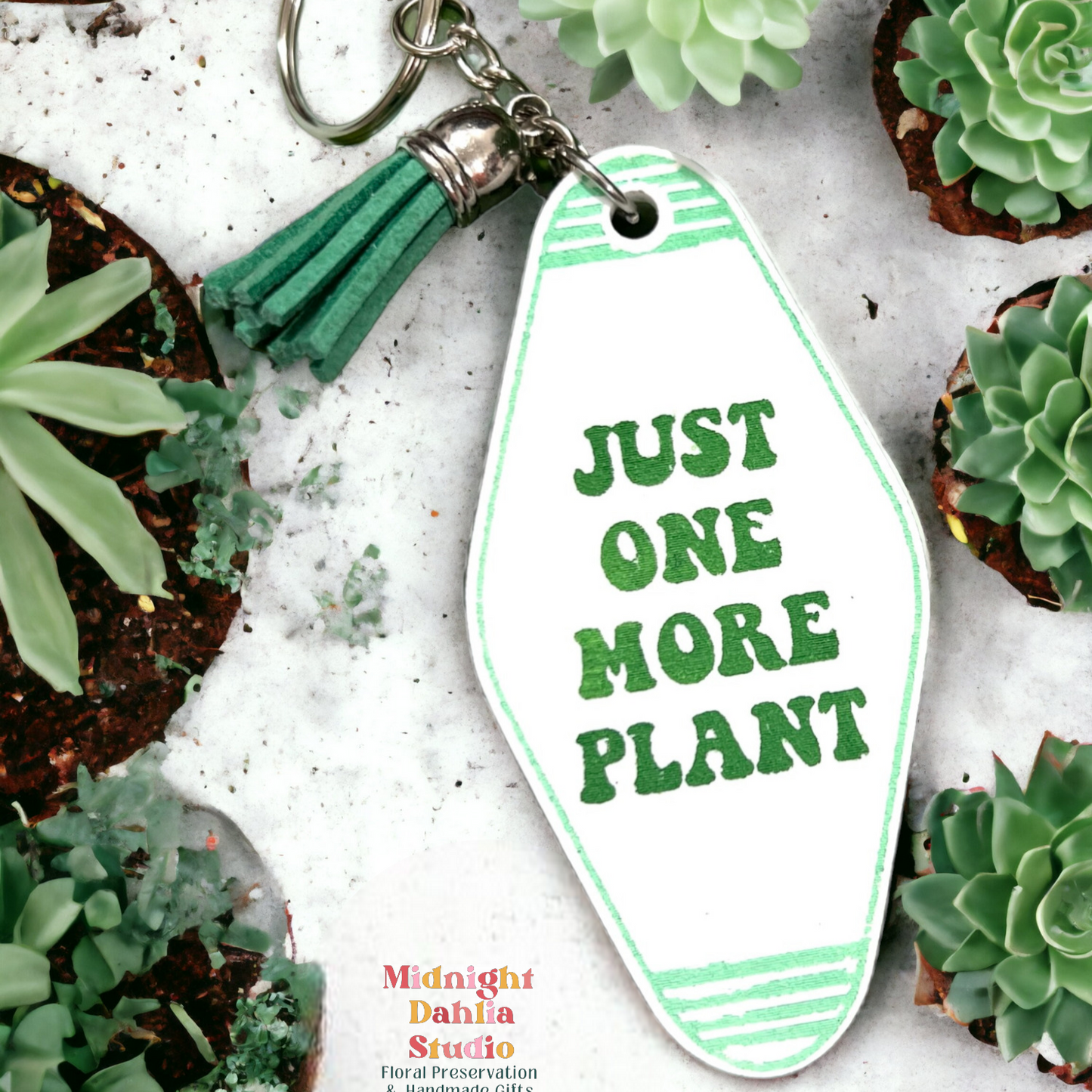 a retro motel keychain made of acrylic that reads just one more plant