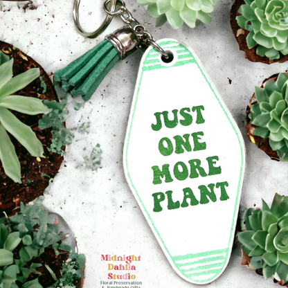 a retro motel keychain made of acrylic that reads just one more plant