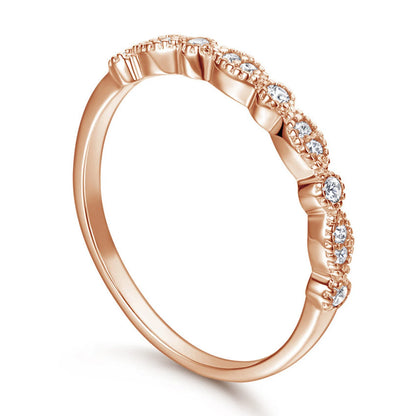 Rose gold ring with small diamonds on a white background