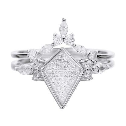 Diamond ring with a textured diamond-shaped center on a white background