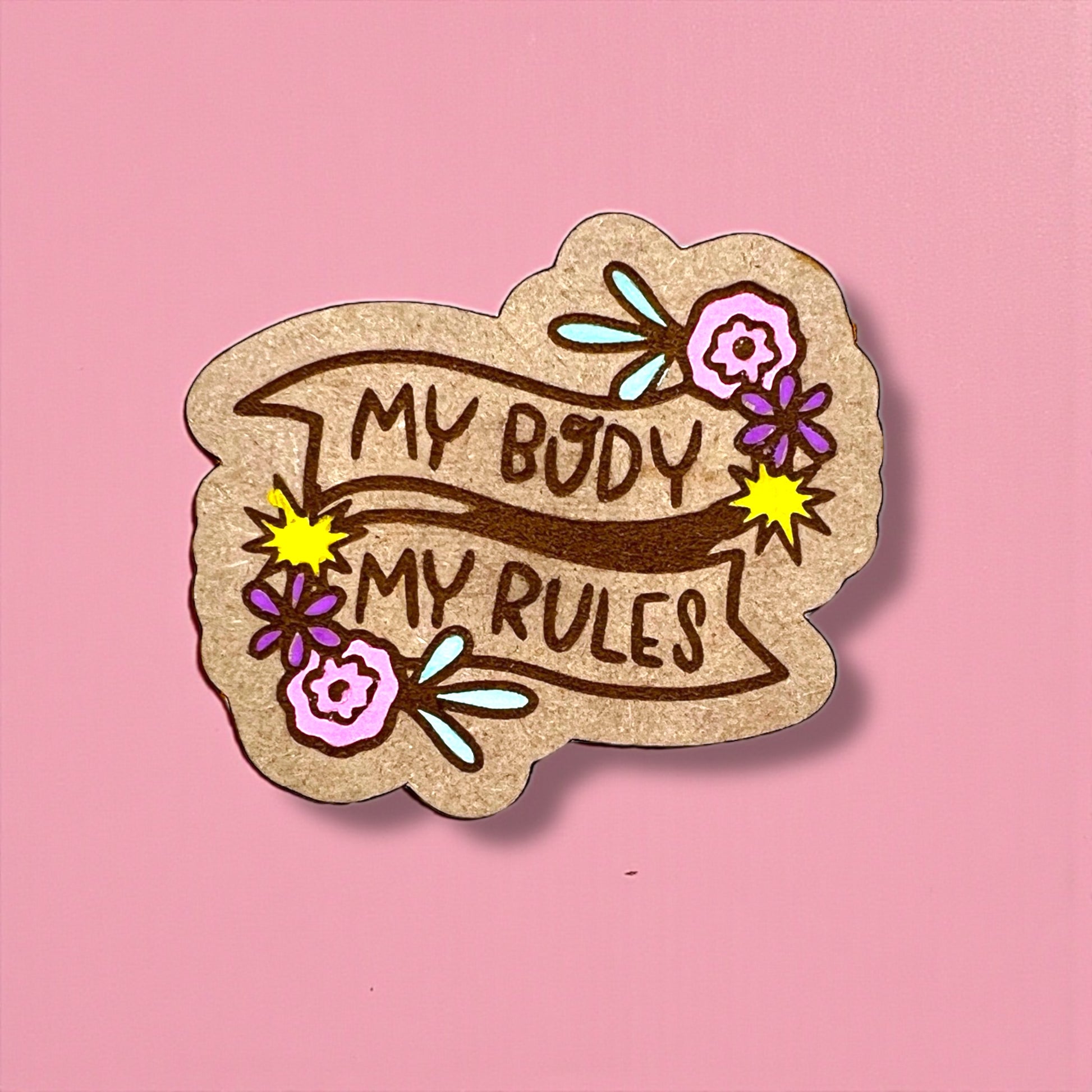 Sticker with 'My Body My Rules' text on a pink background