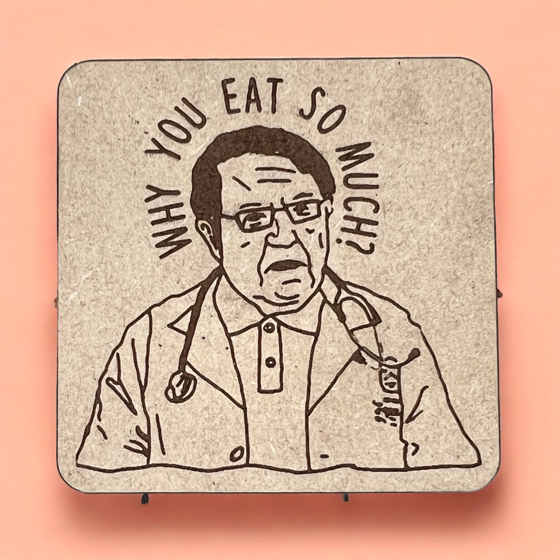 A square magnet with a humorous quote printed on it, placed against a pink background.