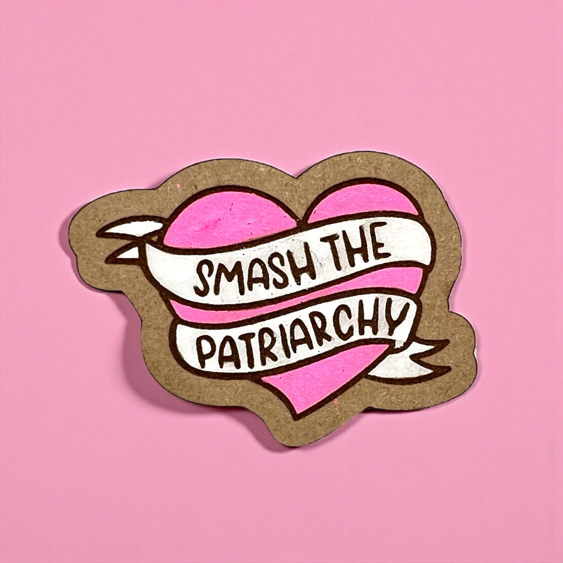 Heart-shaped sticker with 'Smash the Patriarchy' text on a pink background
