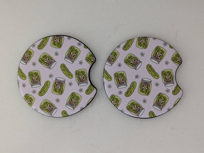 Two round coasters with a green and white pattern on a white background
