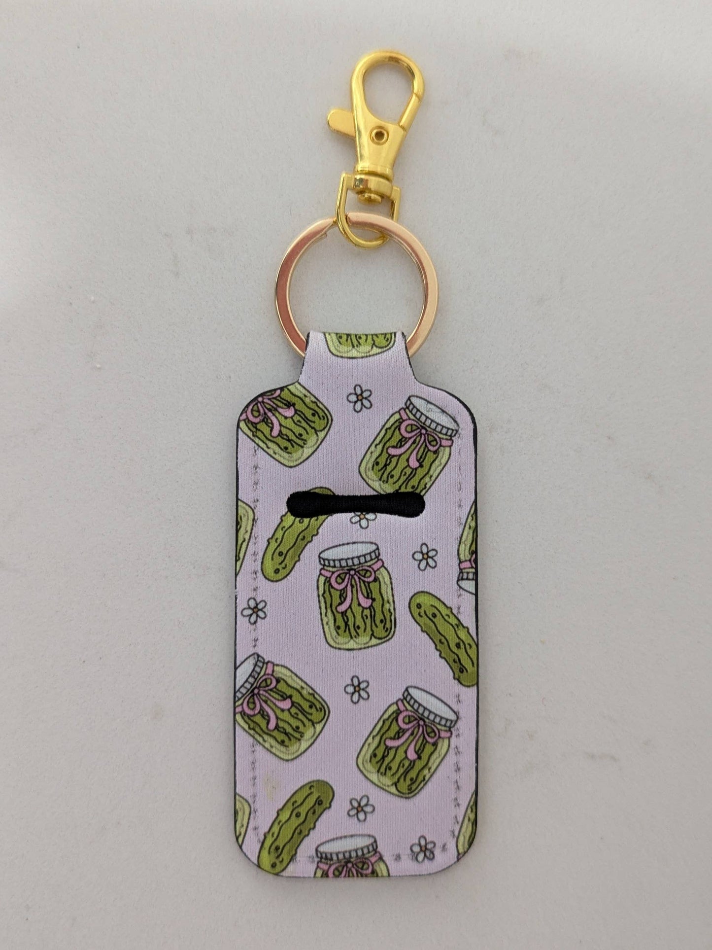 Keychain with pickle pattern on a light gray background
