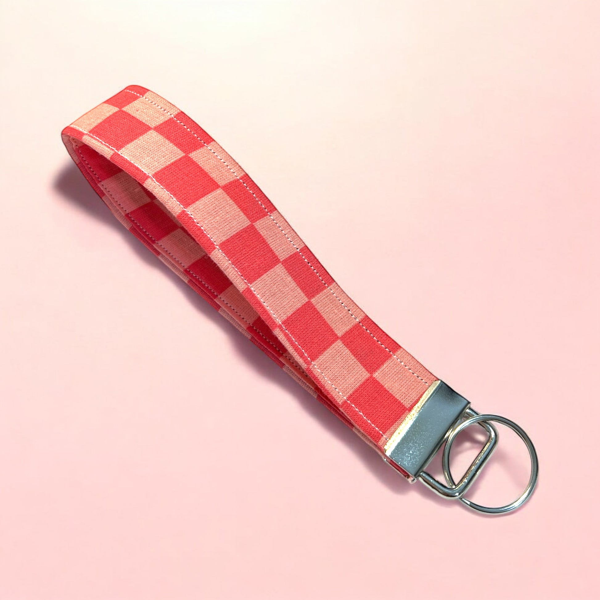 a handmade fabric wristlet keychain key chain against a pastel background