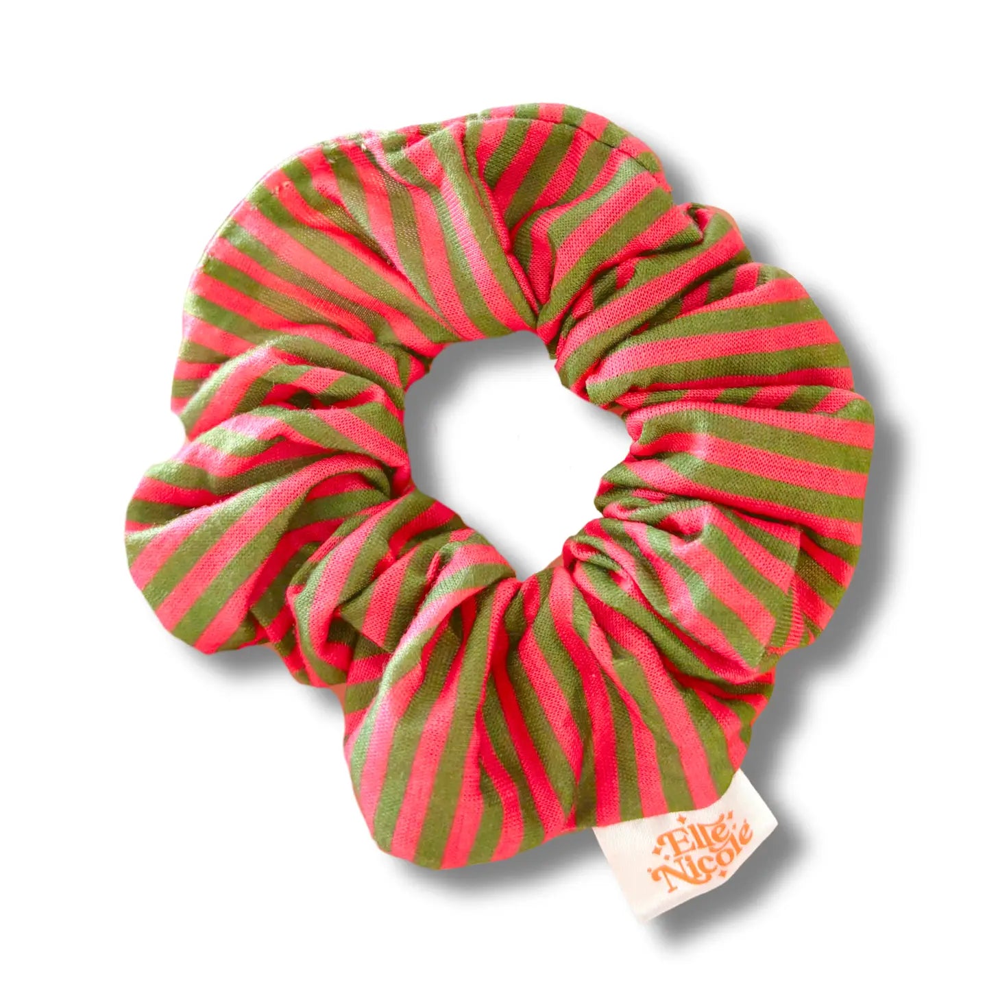 pink and green striped scrunchie with a brand tag on a white background