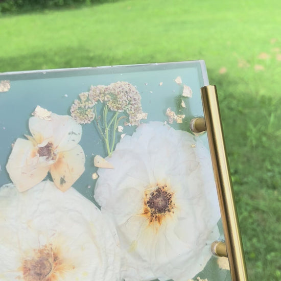 a clear resin tray with white flowers embedded