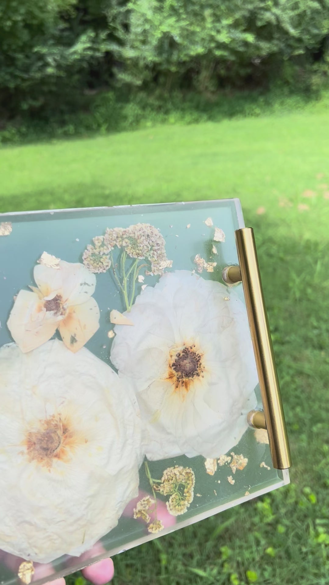 a clear resin tray with white flowers embedded