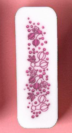 White rectangular object with pink floral pattern on a pink background