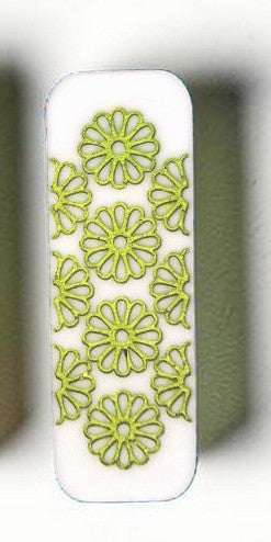 White rectangular object with green floral patterns on a white background