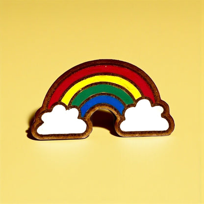 Rainbow-shaped object with clouds on a yellow background