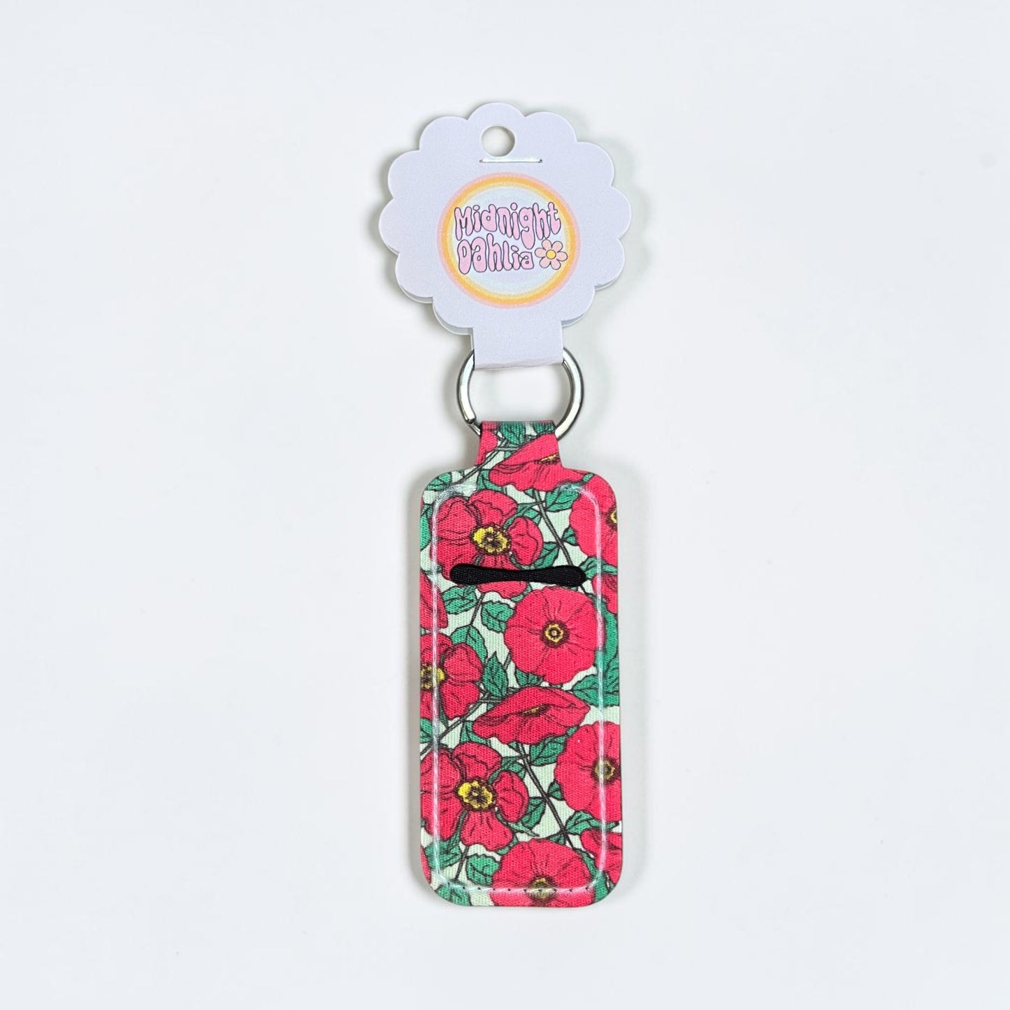 Floral-patterned keychain with a visible brand label on a white background