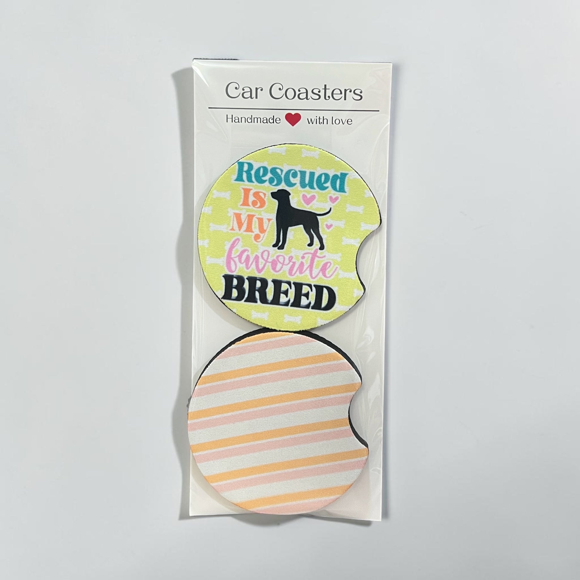 Packaged car coaster with 'Rescued is my favorite breed' text on a light gray background