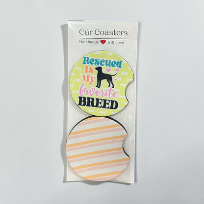Packaged car coaster with 'Rescued is my favorite breed' text on a light gray background